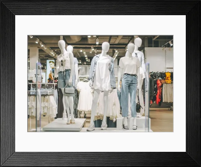 Framed Print : Mannequins in denim and white clothes in clothing store in shopping mall Framed Print : Mannequins in denim and white clothes in clothing store in shopping mall