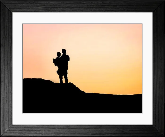 Framed Print : Minimalist silhouette of a grandfather holding his grandson on a hilltop in Cape Zebib Framed Print : Minimalist silhouette of a grandfather holding his grandson on a hilltop in Cape Zebib