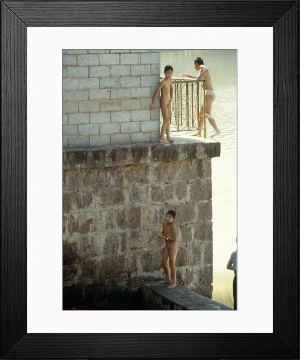 Framed Print : Boys and teenagers having fun in a river in the ancient town Feng Huang in Hunan Province of China Framed Print : Boys and teenagers having fun in a river in the ancient town Feng Huang in Hunan Province of China
