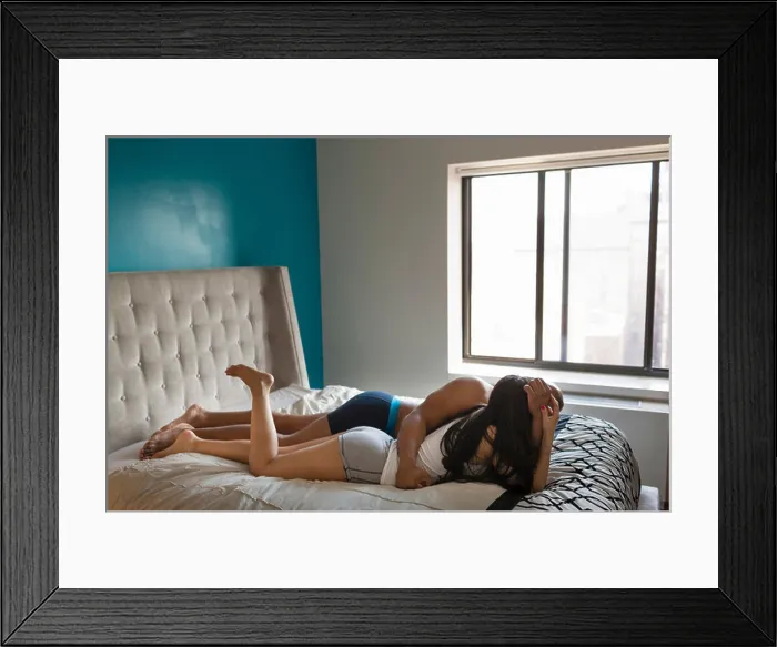 Framed Print : Mid adult couple embracing on bed
