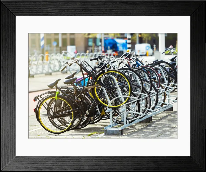 Framed Print : Many bikes parked in the street. Different used bicycles on parking lot. Healthy city transport in Netherlands Framed Print : Many bikes parked in the street. Different used bicycles on parking lot. Healthy city transport in Netherlands