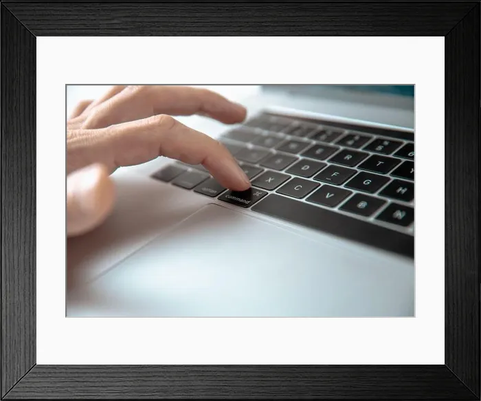 Framed Print : close up. man pressing the command key on his laptop Framed Print : close up. man pressing the command key on his laptop