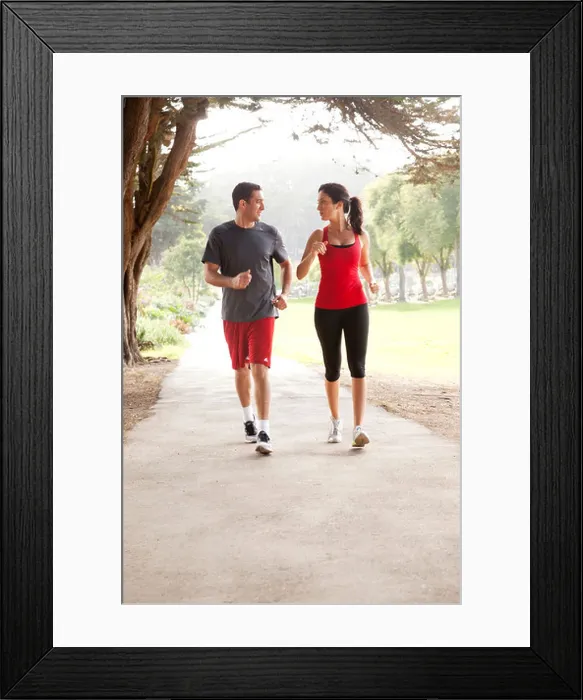 Framed Print : Two joggers are running along a path Framed Print : Two joggers are running along a path