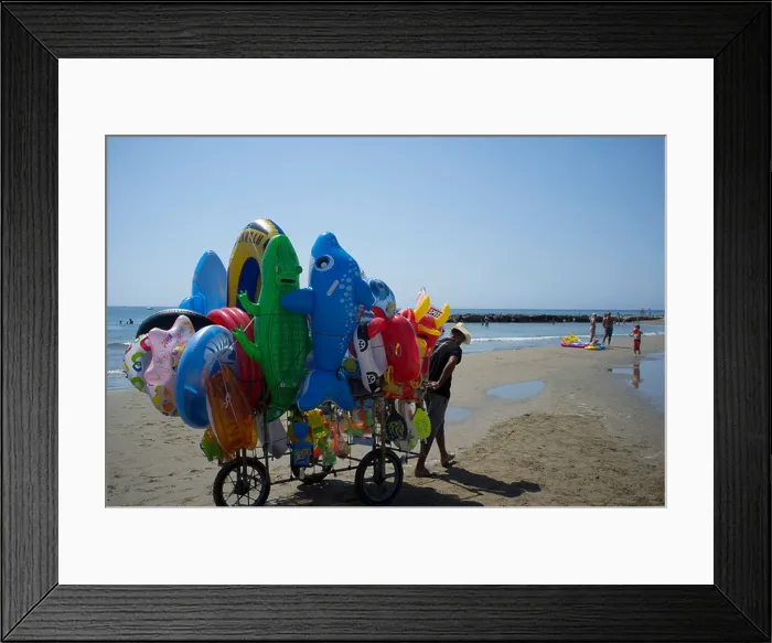 Framed Print : A vendor selling inflatable beach toys at outside Rome, Italy Framed Print : A vendor selling inflatable beach toys at outside Rome, Italy