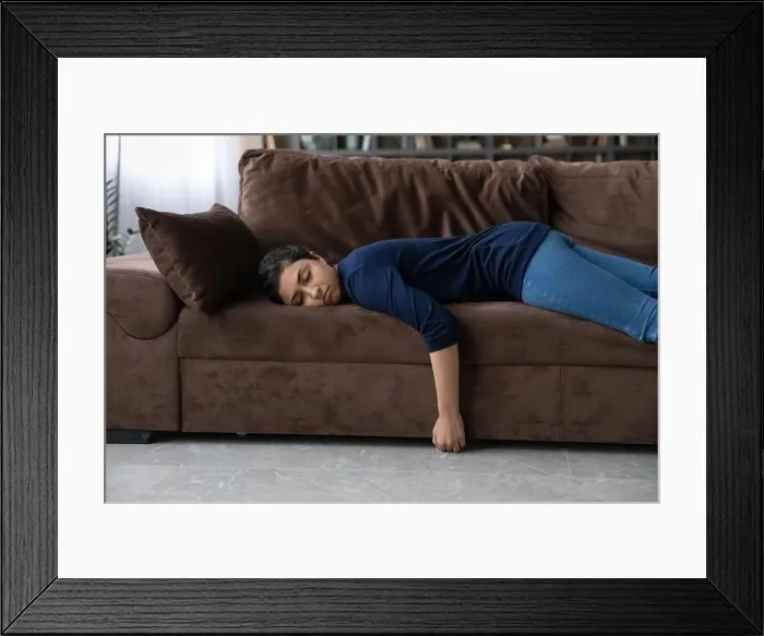 Framed Print : Tired Indian woman sleep on couch at home Framed Print : Tired Indian woman sleep on couch at home