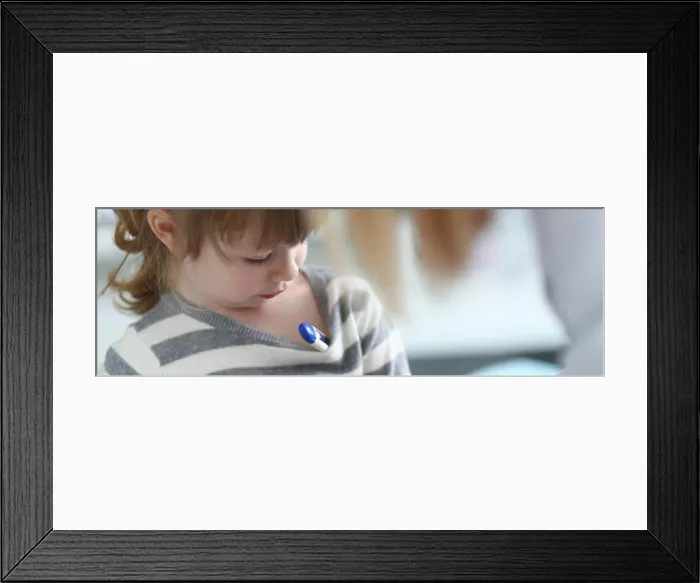 Framed Print : Cute pensive little girl with thermometer under her armpit Framed Print : Cute pensive little girl with thermometer under her armpit