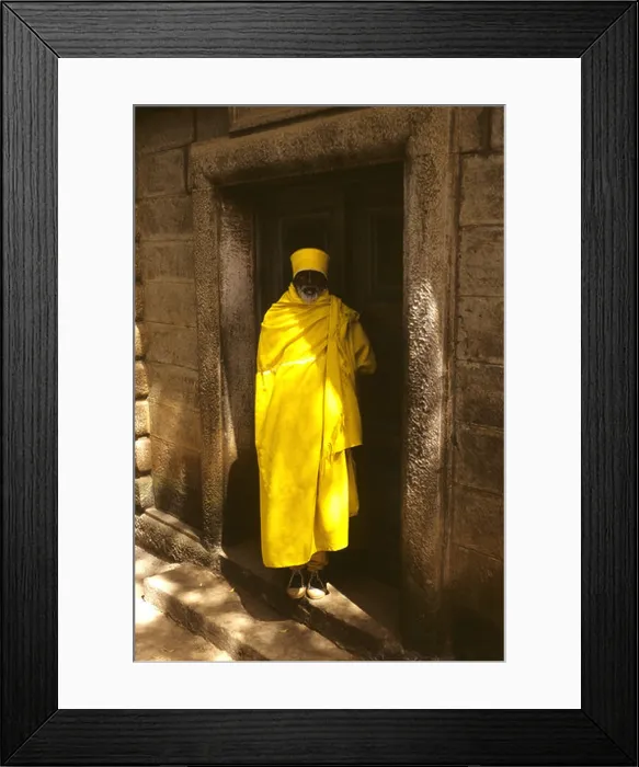 Framed Print : Yellow clad Ethiopian priest or monk as gurdain to a family tomb in Addis Ababa Framed Print : Yellow clad Ethiopian priest or monk as gurdain to a family tomb in Addis Ababa