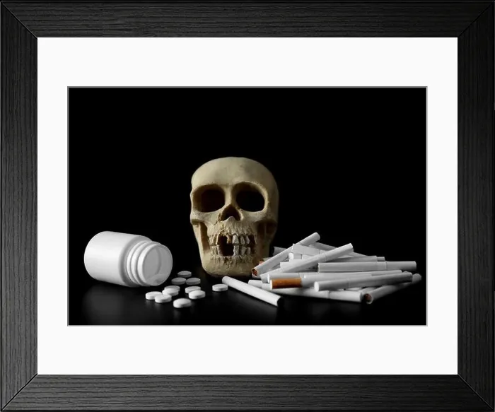 Framed Print : Skull, pile of cigarettes and pills on black background Framed Print : Skull, pile of cigarettes and pills on black background