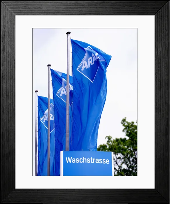 Framed Print : Aral flags blowing in the wind, at a car wash