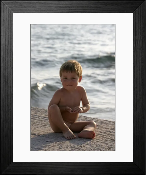 Framed Print : Young boy naked nude or bare sitting by the sea in Saronida Greece Framed Print : Young boy naked nude or bare sitting by the sea in Saronida Greece