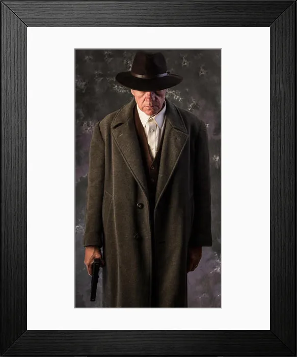 Framed Print : Image of sinister looking man wearing overcoat and hat holding automatic pistol to one side against portrait background Framed Print : Image of sinister looking man wearing overcoat and hat holding automatic pistol to one side against portrait background