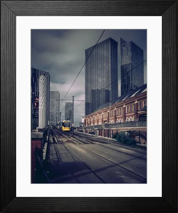 Framed Print : A Bee Network tram in Manchester against the backdrop of Deansgate Square tower skyscrapers with dark cloudy sky Framed Print : A Bee Network tram in Manchester against the backdrop of Deansgate Square tower skyscrapers with dark cloudy sky