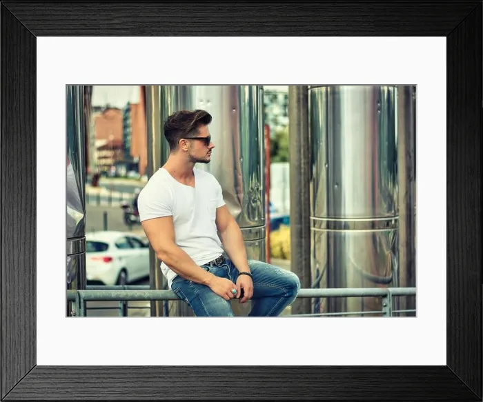 Framed Print : Handsome young man in white t-shirt outdoor in city setting Framed Print : Handsome young man in white t-shirt outdoor in city setting