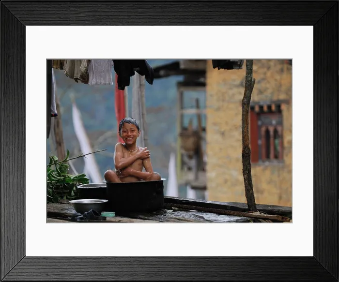 Framed Print : Bhutan, Trongsa District, Jigme Singye Wangchuck National Park, Korphu, daily life in the village, little boy bathing Framed Print : Bhutan, Trongsa District, Jigme Singye Wangchuck National Park, Korphu, daily life in the village, little boy bathing