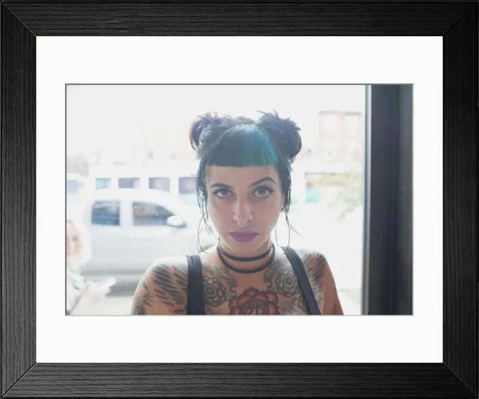 Framed Print : A young woman with black and blue hair