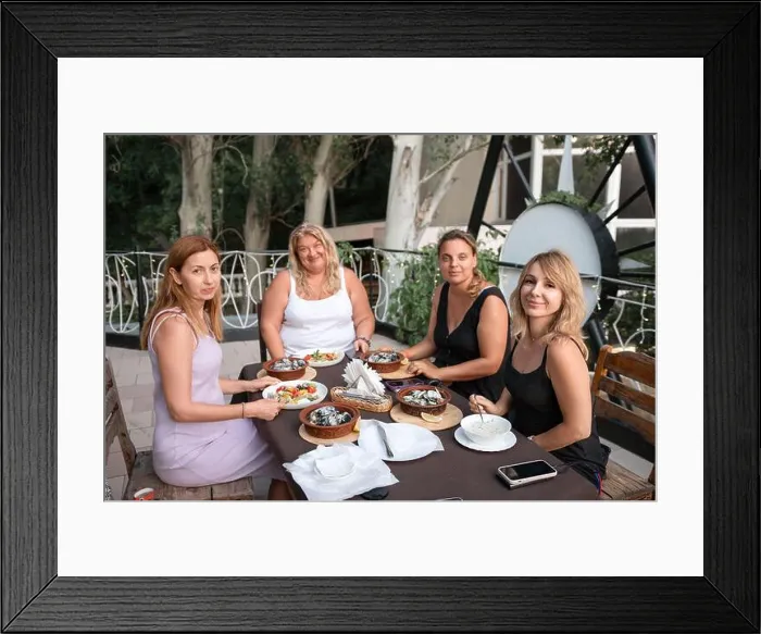 Framed Print : Women Friends Restaurant Dinner Outdoor - Four friends enjoy a meal together at a restaurant patio