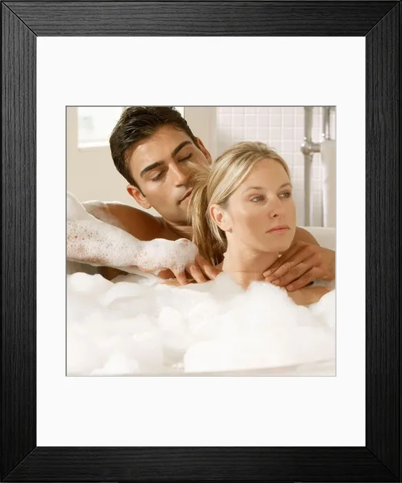 Framed Print : Close-up of a young couple in a bubble bath Framed Print : Close-up of a young couple in a bubble bath