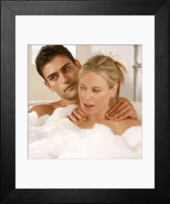 Framed Print : Close-up of a young couple in a bubble bath Framed Print : Close-up of a young couple in a bubble bath