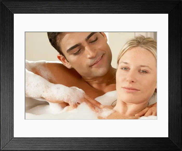 Framed Print : Portrait of a young woman getting a massage from a young man in a bubble bath Framed Print : Portrait of a young woman getting a massage from a young man in a bubble bath