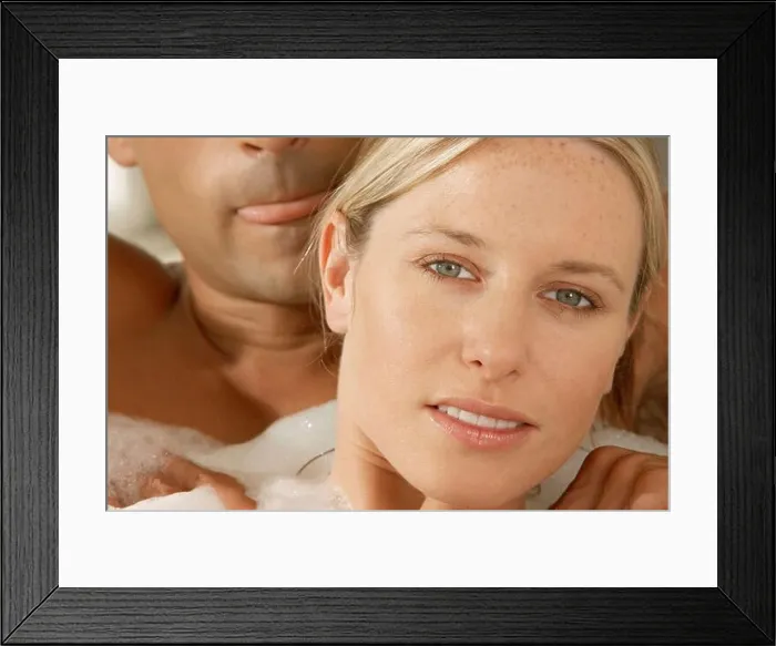 Framed Print : Portrait of a young woman getting a massage form a young man in a bubble bath Framed Print : Portrait of a young woman getting a massage form a young man in a bubble bath