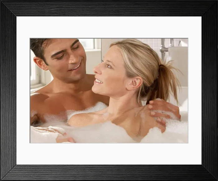Framed Print : Close-up of a young couple in a bubble bath Framed Print : Close-up of a young couple in a bubble bath