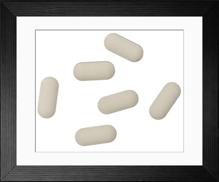 Framed Print : White oval tablet on isolated background, close up. Top view Framed Print : White oval tablet on isolated background, close up. Top view