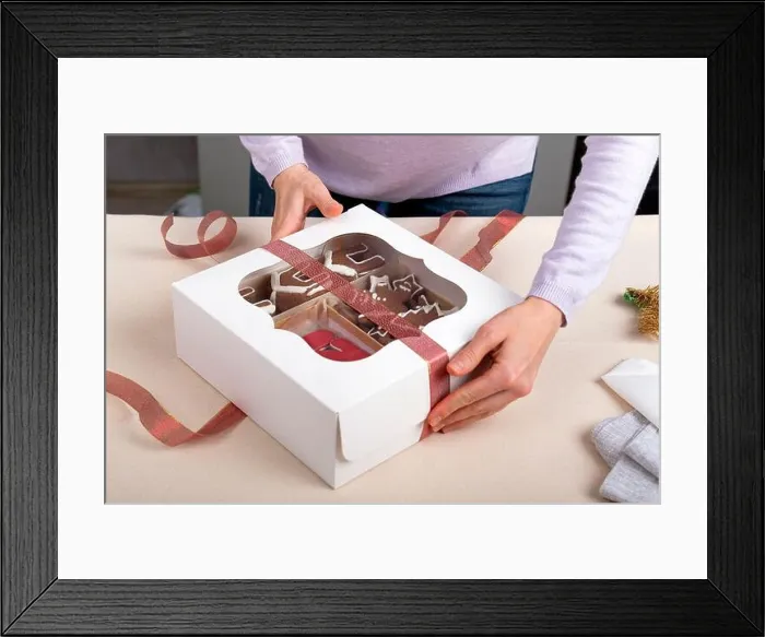 Framed Print : Process of packing confectionery gift box. Cookies in cardboard box Framed Print : Process of packing confectionery gift box. Cookies in cardboard box