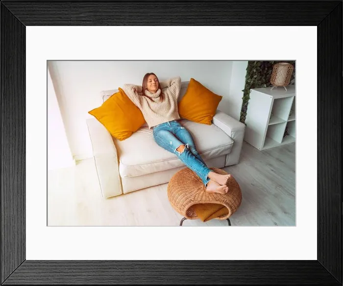 Framed Print : Calm satisfied woman relaxing or sleeping on the sofa in living room Framed Print : Calm satisfied woman relaxing or sleeping on the sofa in living room
