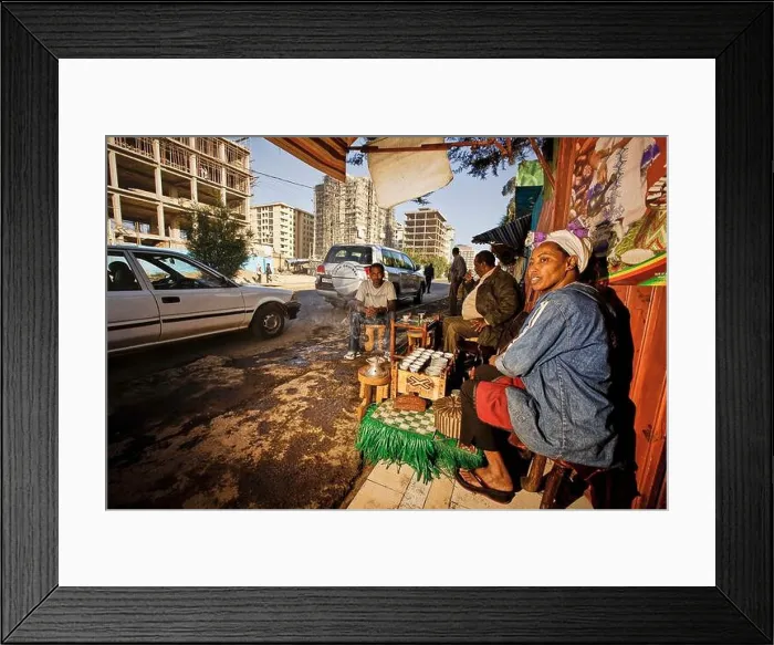 Framed Print : A woman cultivates the Ethiopian coffee tradition in her street bar in a development area
