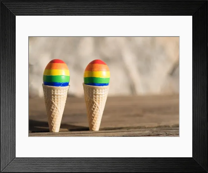 Framed Print : Lgbt couple family. Eggs with lgbt flag color in ice cream waffle cone on nature spring outdoor background Framed Print : Lgbt couple family. Eggs with lgbt flag color in ice cream waffle cone on nature spring outdoor background