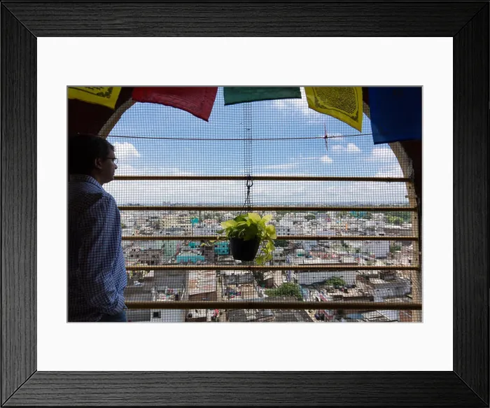Framed Print : Indian man stands in the balcony on a fifth floor balcony overlooking the city of Hyderabad, 18 September 2016 Framed Print : Indian man stands in the balcony on a fifth floor balcony overlooking the city of Hyderabad, 18 September 2016