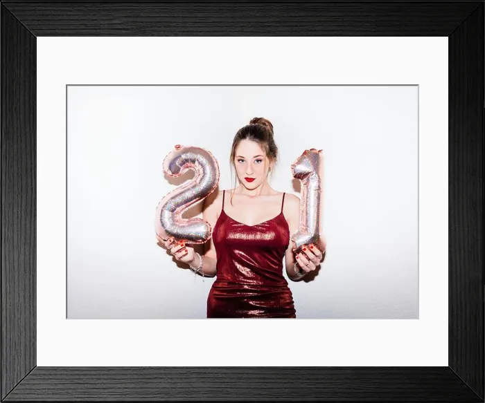 Framed Print : Young woman celebrating her 21st birthday illuminated with hard flash light Framed Print : Young woman celebrating her 21st birthday illuminated with hard flash light