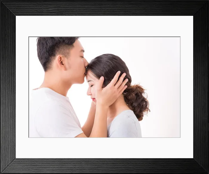 Framed Print : A man kissing his woman's head with love and affection, the woman is enjoying the romance Framed Print : A man kissing his woman's head with love and affection, the woman is enjoying the romance
