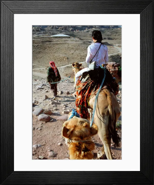 Framed Print : Bedouin guide with tourist girl in a camel ride, Petra, Jordan Framed Print : Bedouin guide with tourist girl in a camel ride, Petra, Jordan