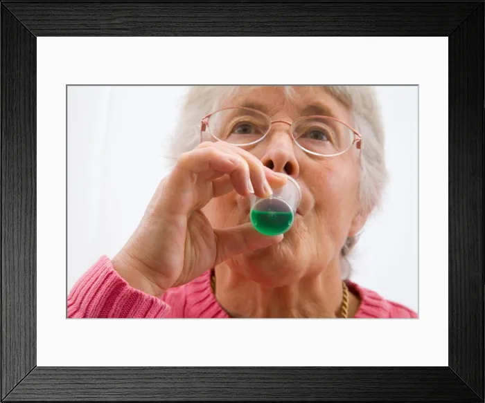 Framed Print : Close up Elderly woman sipping green mint mouthwash for oral hygiene Framed Print : Close up Elderly woman sipping green mint mouthwash for oral hygiene