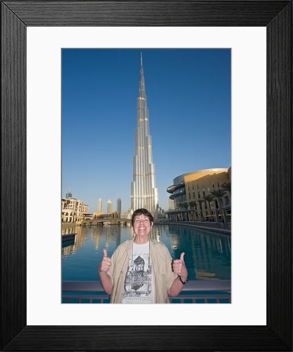 Framed Print : American visitor poses in front of Burj Khalifa, tallest man made structure ever built Framed Print : American visitor poses in front of Burj Khalifa, tallest man made structure ever built