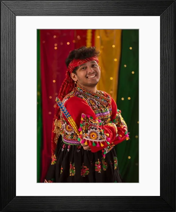 Framed Print : portrait of happy young man in kedia and dhoti holding dandiyas during Navratri celebrations Framed Print : portrait of happy young man in kedia and dhoti holding dandiyas during Navratri celebrations