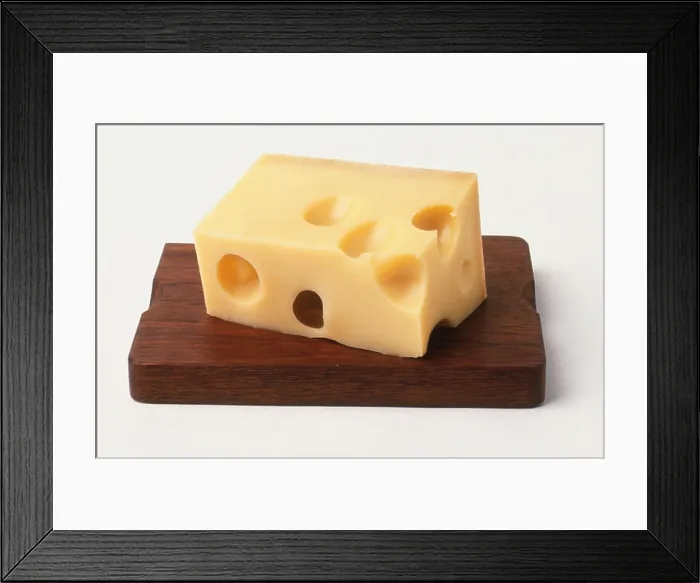 Framed Print : Rectangular block of cheese with holes on wooden board, close up Framed Print : Rectangular block of cheese with holes on wooden board, close up