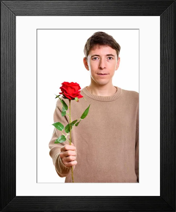 Framed Print : Studio shot of man holding red rose