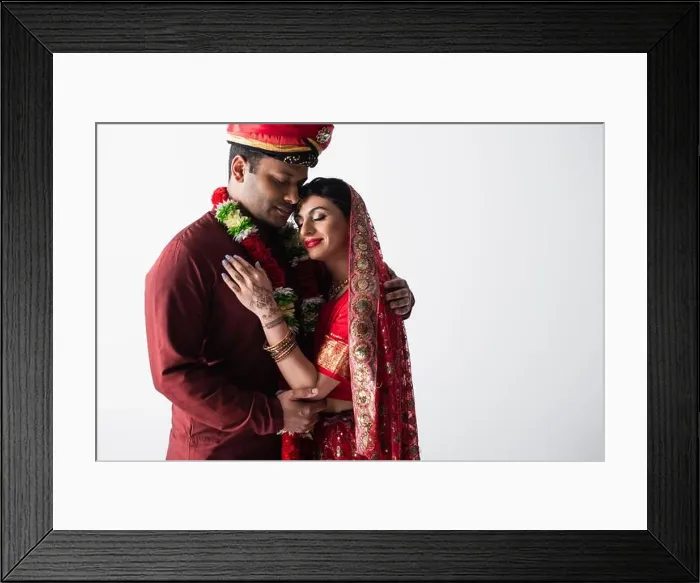 Framed Print : happy indian couple of husband and wife in traditional clothing hugging isolated on grey