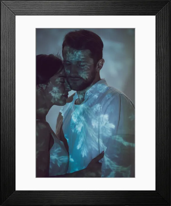 Framed Print : two people in love hugging while standing on dark place Framed Print : two people in love hugging while standing on dark place