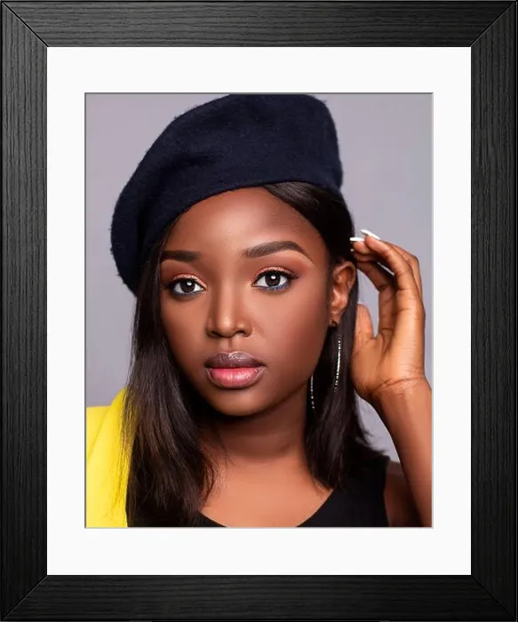 Framed Print : Close up portrait of young beautiful African lady on a grey background with a hat with beautiful skin and eyes Framed Print : Close up portrait of young beautiful African lady on a grey background with a hat with beautiful skin and eyes