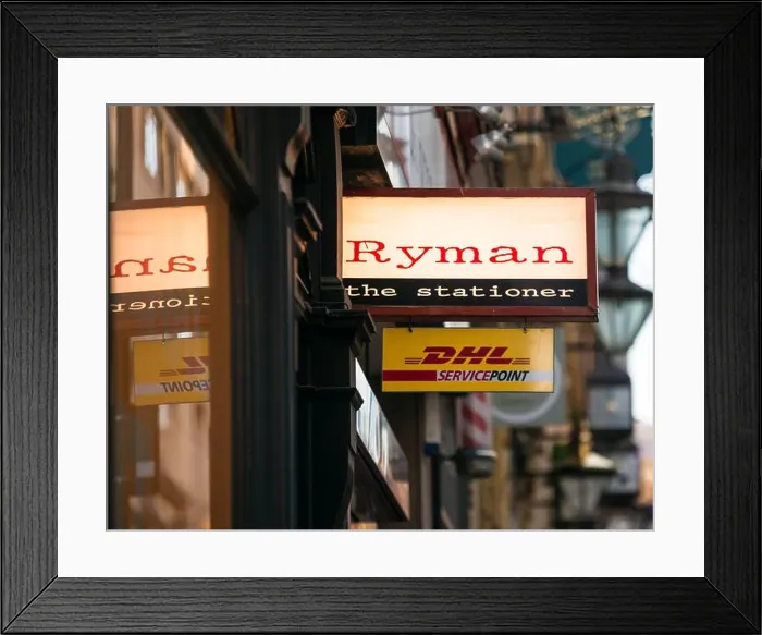Framed Print : Ryman the stationer stationery store shop sign with window reflection, and DHL Service Point sign below, Birmingham, UK Framed Print : Ryman the stationer stationery store shop sign with window reflection, and DHL Service Point sign below, Birmingham, UK