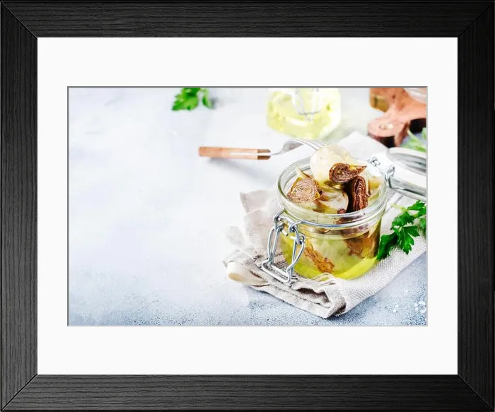 Framed Print : Artichokes in olive oil in jar with lemon and herbs on gray kitchen table background, selective focus Framed Print : Artichokes in olive oil in jar with lemon and herbs on gray kitchen table background, selective focus