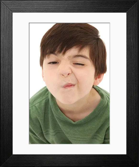 Framed Print : Funny seven year old french american boy making sneeze or nose tickle face Framed Print : Funny seven year old french american boy making sneeze or nose tickle face