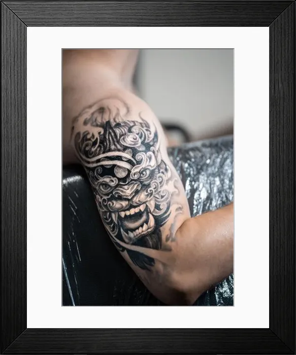 Framed Print : stylish black tattoo of Japanese demon mask on man hand, body art Framed Print : stylish black tattoo of Japanese demon mask on man hand, body art