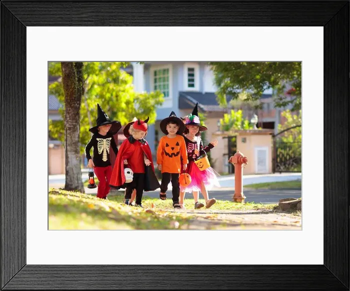 Framed Print : Child in Halloween costume. Mixed race Asian and Caucasian kids trick or treat on suburban street Framed Print : Child in Halloween costume. Mixed race Asian and Caucasian kids trick or treat on suburban street