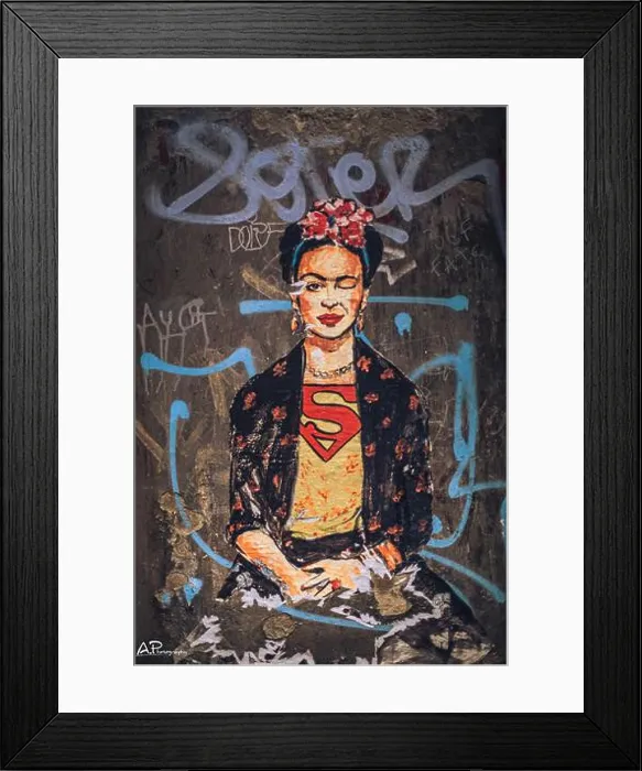 Framed Print : A vertical shot of Frida Kahlo portrait with superman shirt on a wall with graffiti Framed Print : A vertical shot of Frida Kahlo portrait with superman shirt on a wall with graffiti