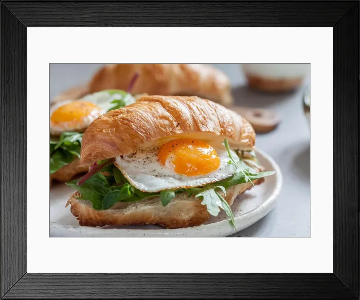 Framed Print : Delicious Breakfast with Croissant sandwiches with Fried Egg, Salad Leaves and avocado Framed Print : Delicious Breakfast with Croissant sandwiches with Fried Egg, Salad Leaves and avocado