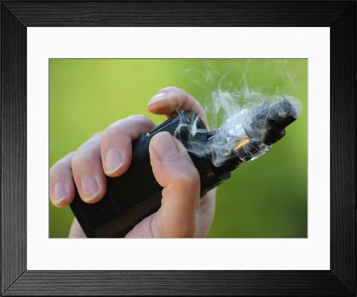 Framed Print : An E Cigarette / Mod in the hand of a man vaping close up photo Framed Print : An E Cigarette / Mod in the hand of a man vaping close up photo